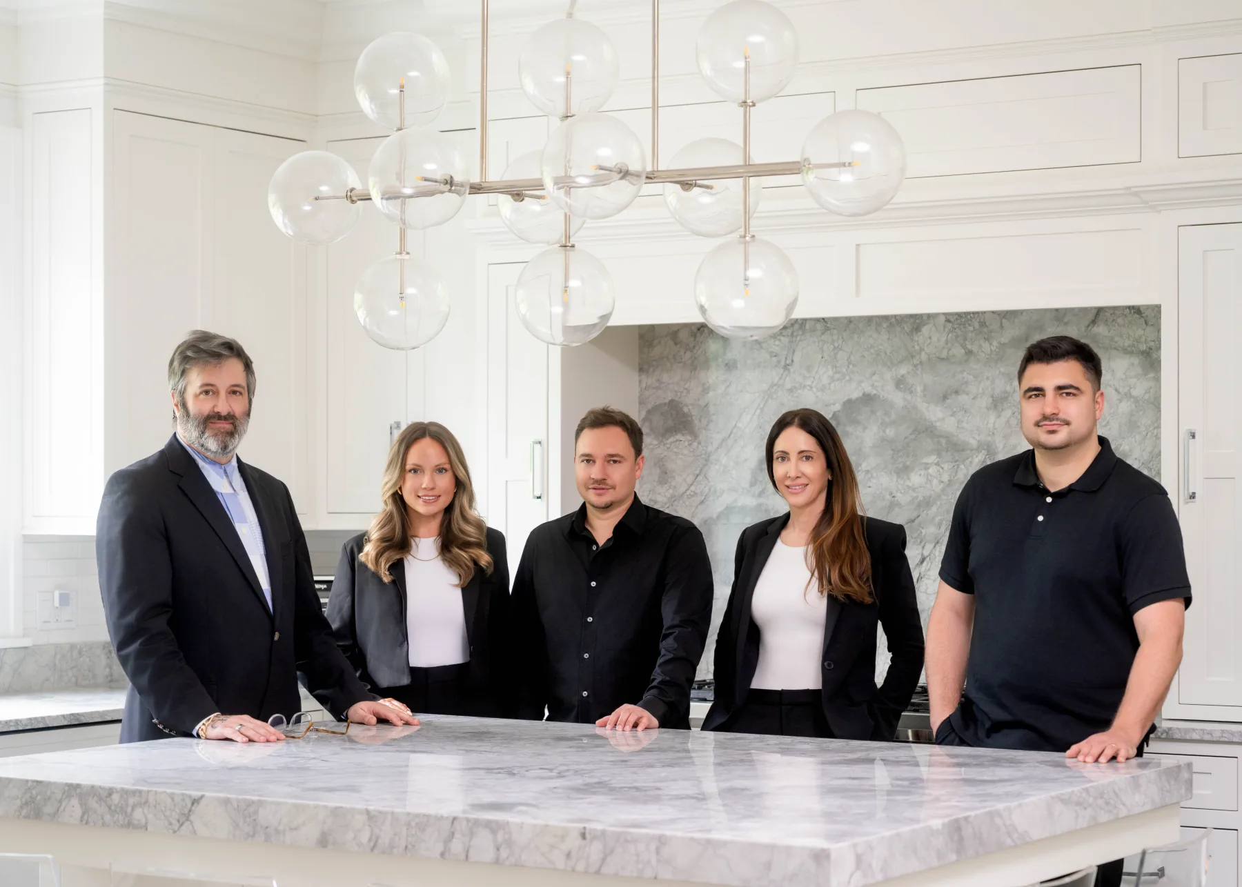 The BMN Boston team working together around a kitchen island
